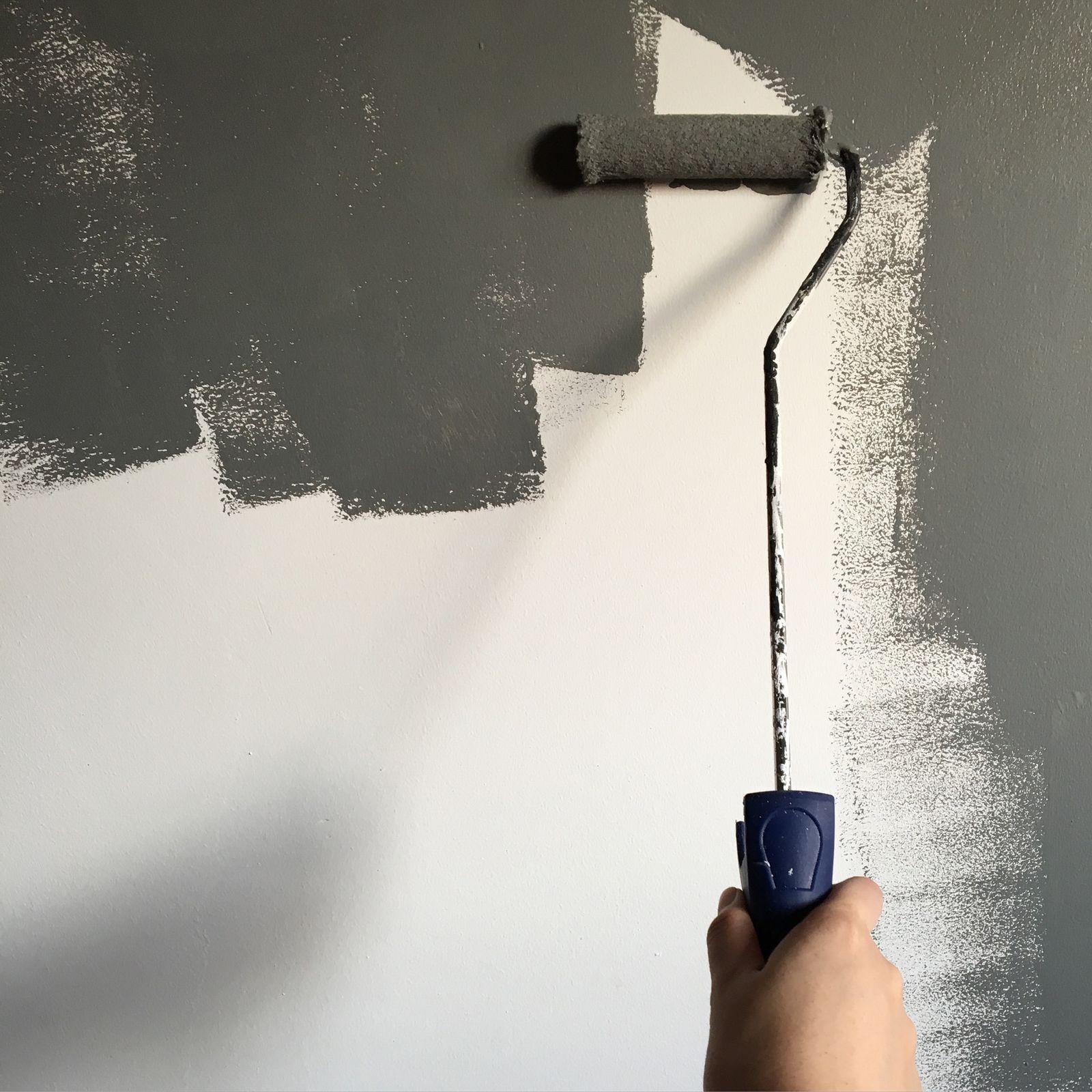 rolling fresh paint on an interior wall